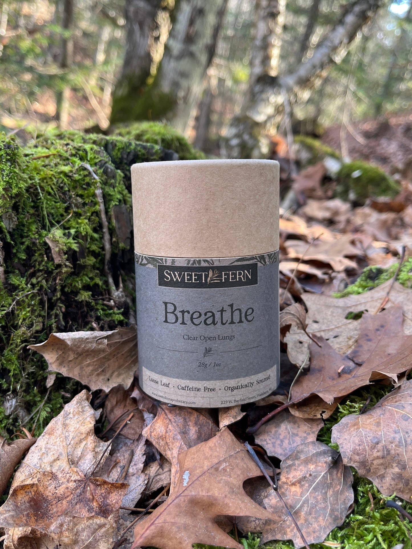 Herbal Tea labeled Breathe setting on forest floor