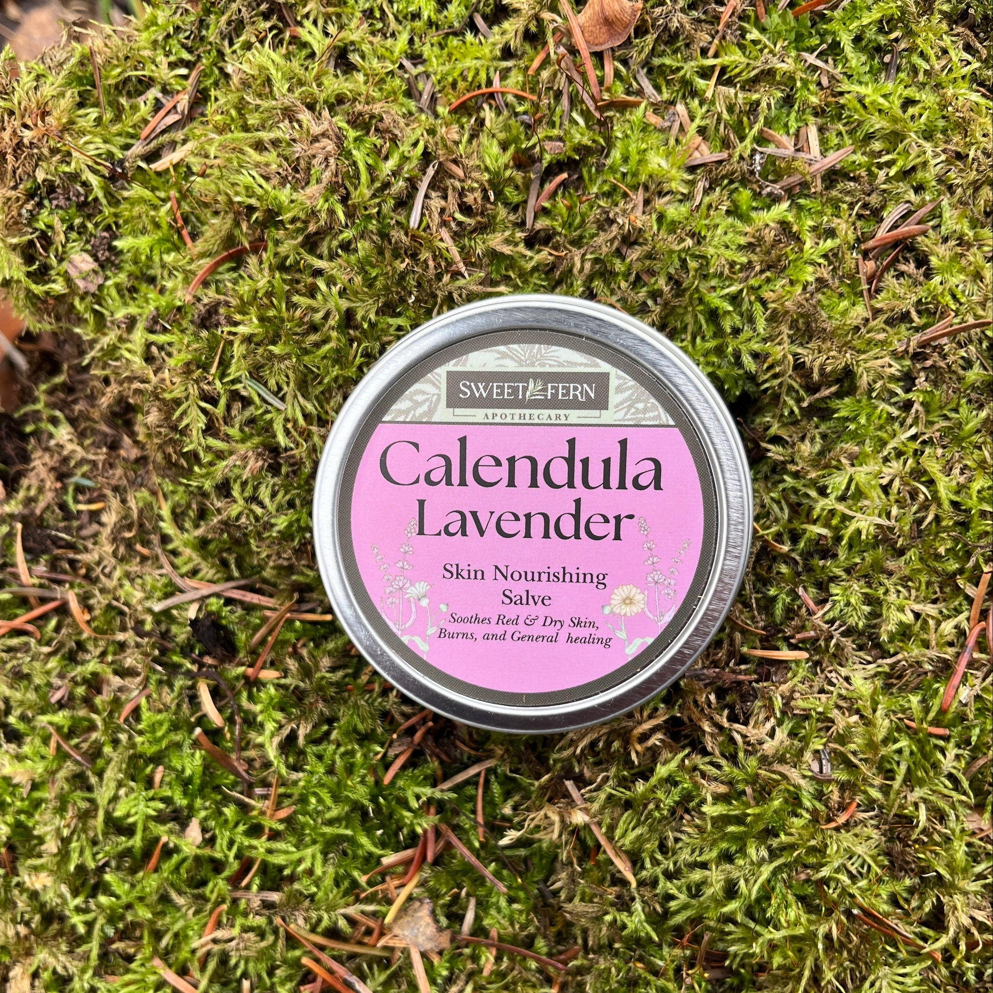 Tin of Calendula Lavender salve on a bed of green moss