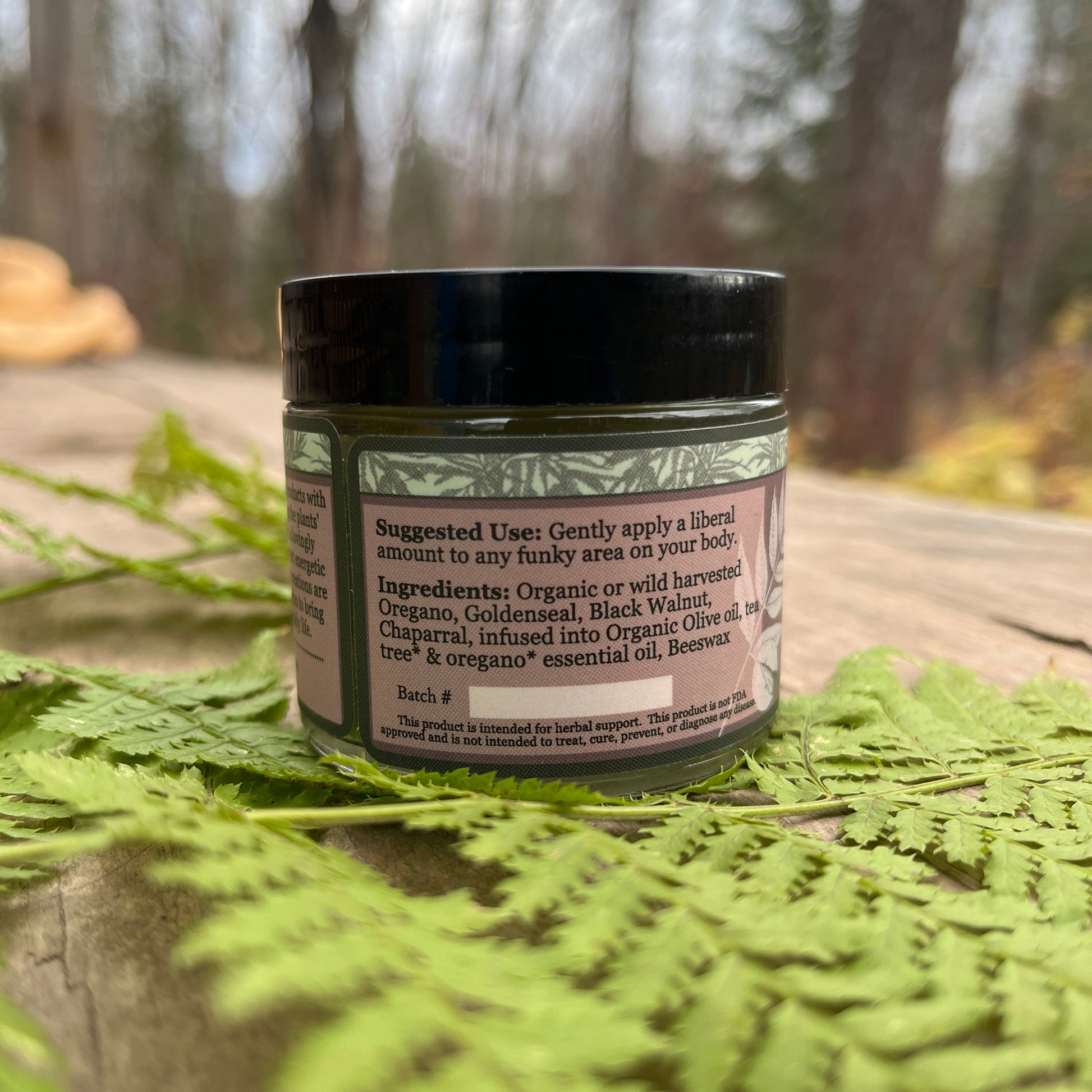 Jar of Get the Funk out, showing the ingredients on a wooden surface with blurred natural background